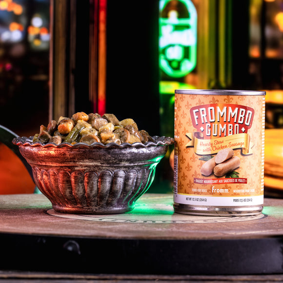 Can of Frommbo Guma with a bowl of pet food on a bar counter.