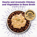 Pet food bowl with kibble and a scoop of wet food, labeled 'Hearty and Aromatic Chicken and Vegetables in Bone Broth'.