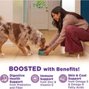 Woman feeding a dog from a bowl indoors, with text about pet food benefits.