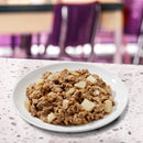 Plate of oatmeal with apples on a marble countertop