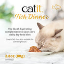 Catit Fish Dinner cat food packaging with a cat eating from a bowl on a marble surface.