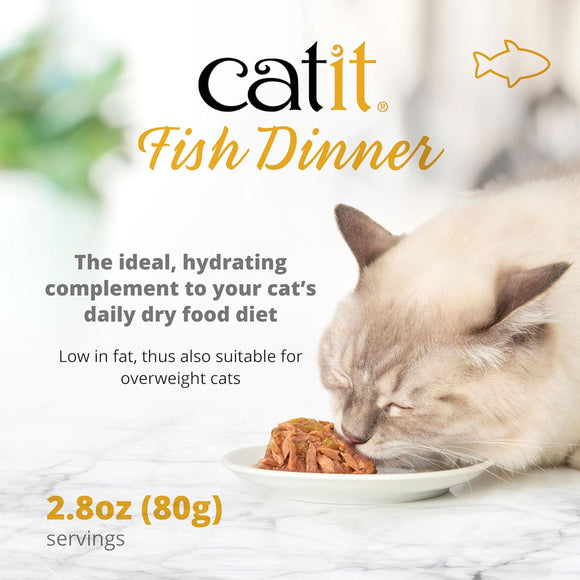 Catit Fish Dinner cat food packaging with a cat eating from a bowl on a marble surface.