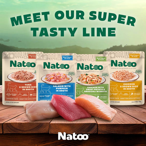 Natoo pet food packages on a wooden surface with a scenic background