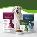 Dog with Fromm Family Nutritionals dog food packages on a white background
