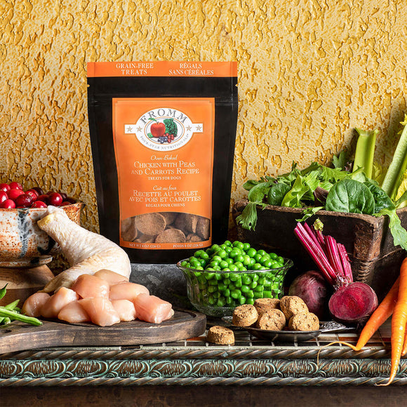 Package of Fromm dog food with fresh vegetables and ingredients on a textured surface
