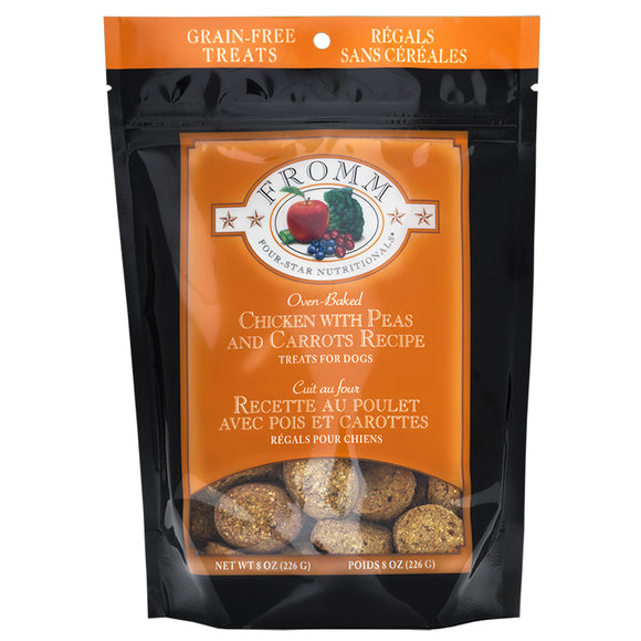 Package of Fromm dog treats with chicken, peas, and carrots on an orange background