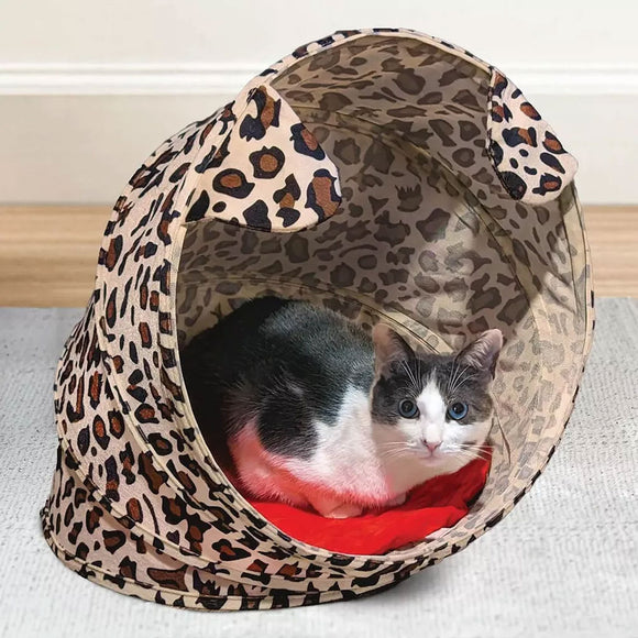 Cat lying inside a leopard print pet tent on a light-colored floor.