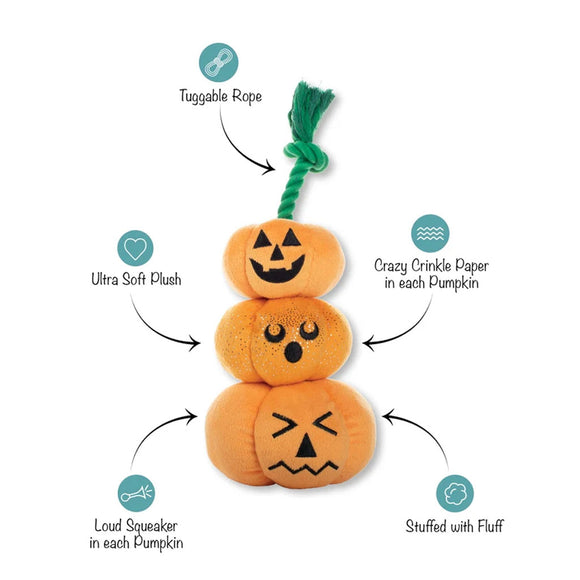 Stack of three orange pumpkin-shaped toys with features highlighted on a white background