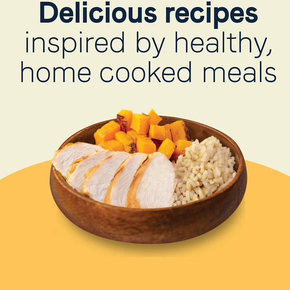 Wooden bowl with sliced chicken, rice, and carrots on a yellow background with text about healthy home-cooked meals.