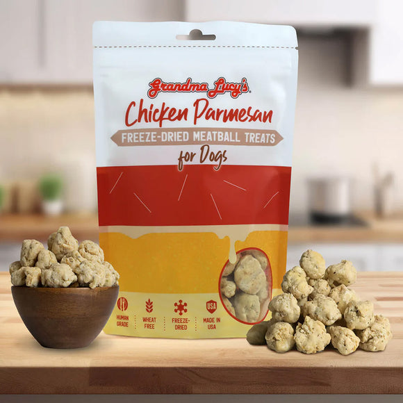 Bag of Grandma Lucy's Chicken Parmesan freeze-dried meatball treats for dogs on a kitchen counter with treats displayed.