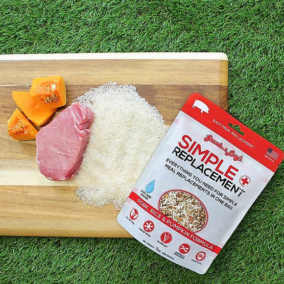 Package of Simple Replacement on a cutting board with meat, rice, and pumpkin.