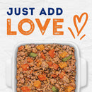 Dog food mix in a dish with 'Just Add Love' text and heart symbol on a light background