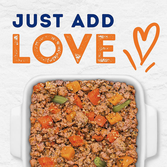 Dog food mix in a dish with 'Just Add Love' text and heart symbol on a light background