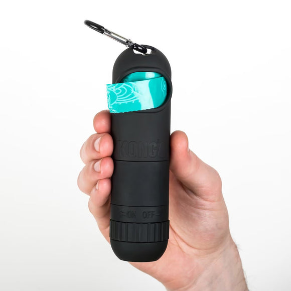 Black pepper spray container with teal component held by a hand on a white background