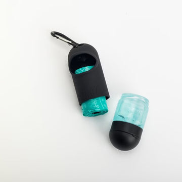 Black and teal dog toy with a carabiner on a white background
