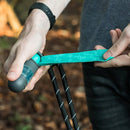 Person holding a teal and black tool with a blurred natural background
