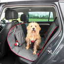 Dog sitting on a car seat cover in a vehicle