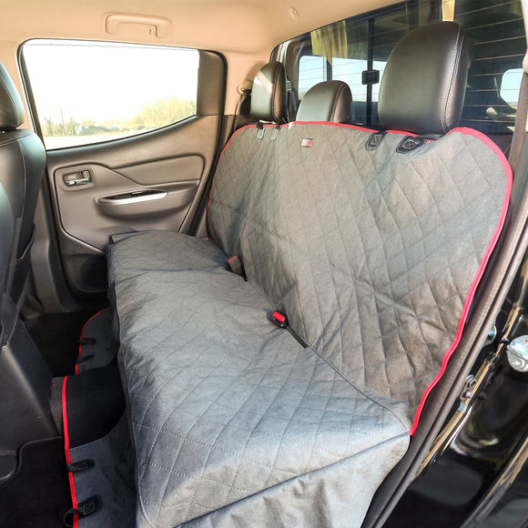 Gray car seat cover with red accents on a vehicle's back seat