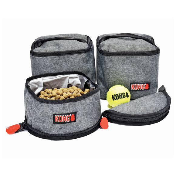 Gray pet travel bag with KONG logo containing dog food and a tennis ball on a white background