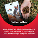 Nulo Trainers dog food package with a hand holding treats on grass