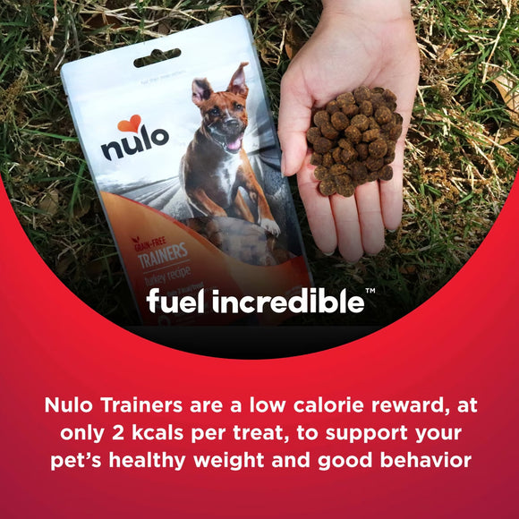 Nulo Trainers dog food package with a hand holding treats on grass