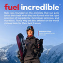 Person holding a snowboard and a dog with mountains in the background, featuring Nulo pet food advertisement.