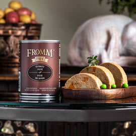 Can of Fromm Pate with sliced loaf on a wooden board