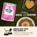 Fromm Puppy canned dog food with heart-shaped treat and bowl of kibble on grass background