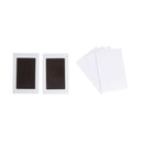 Two black rectangular objects on white cards with a white envelope on a white background