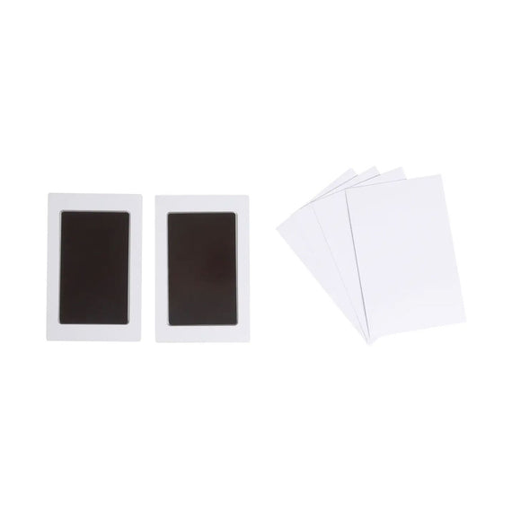 Two black rectangular objects on white cards with a white envelope on a white background