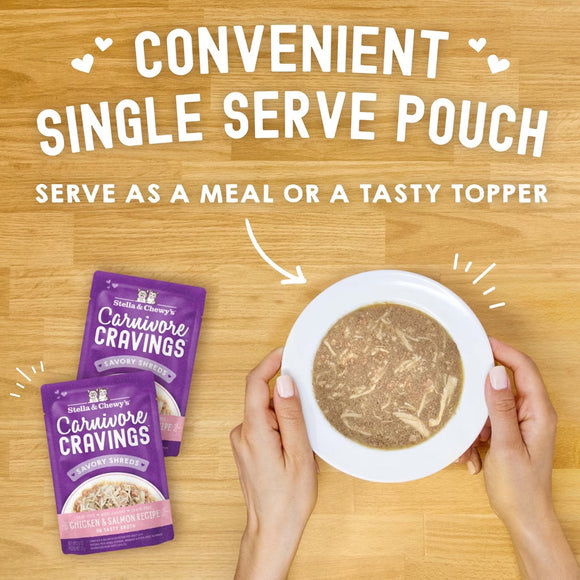 Stella & Chewy's Carnivore Cravings pouches with a bowl of food on a wooden surface.