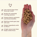Hand holding dog treats with text about their benefits on a beige background