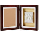 Wooden frame with a white paw print inside on a beige background