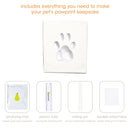 Pet pawprint keepsake kit with air-drying clay, plastic ruler, rolling pin, and double-sided tape on a white background.