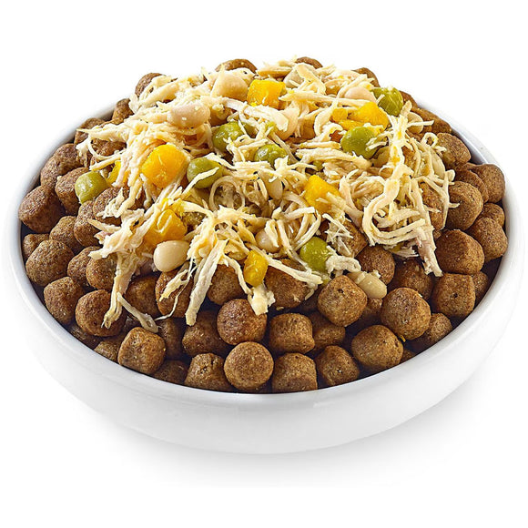 Dog food bowl with kibble, shredded cheese, and vegetables on a white background