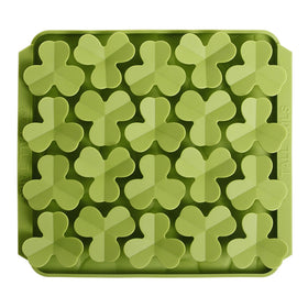 Green silicone mold with clover leaf shapes on a white background