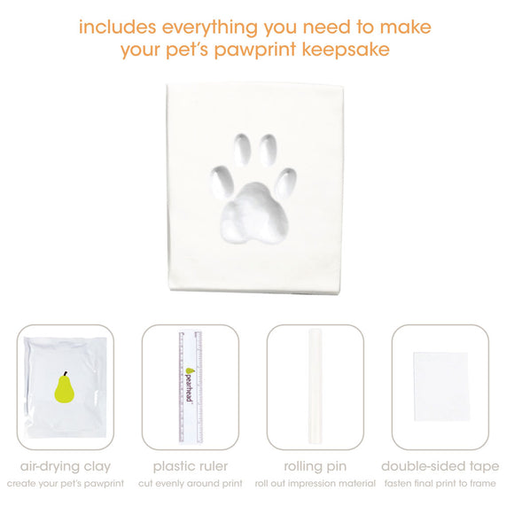 Pet pawprint keepsake kit with air-drying clay, plastic ruler, rolling pin, and double-sided tape on a white background.