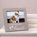 Photo frame with a dog picture and 'Forever in my heart' text on a white surface.