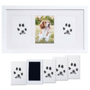 White photo frame with paw print pads and a photo of a dog.
