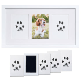 White photo frame with paw print pads and a photo of a dog.