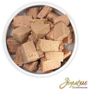 Dog treats in a white bowl with 'Signature' branding on a white background