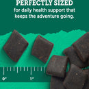 Dark-colored pet treats with a ruler for scale on a green background, text about health support.