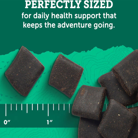 Dark-colored pet treats with a ruler for scale on a green background, text about health support.