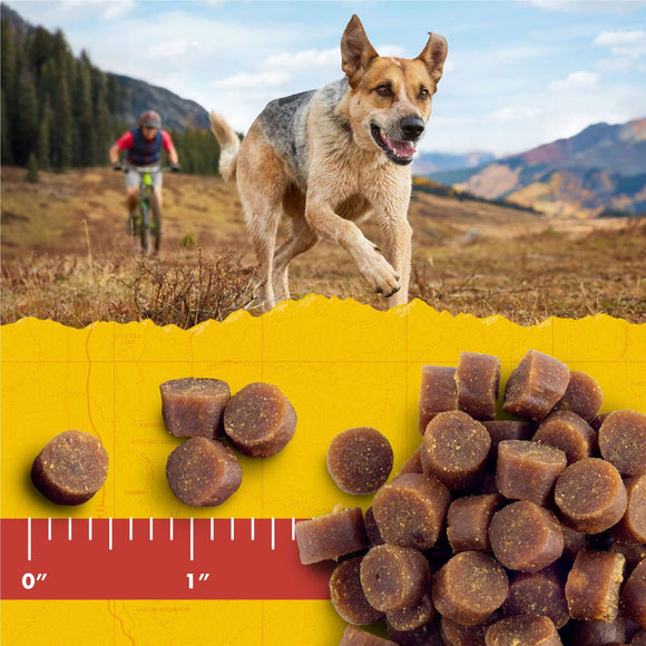 Dog treats on a yellow background with a mountainous landscape in the background