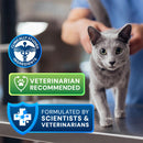 Gray cat being held by a person with product certification badges on a blurred background