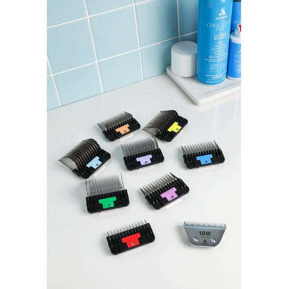 Set of hair clipper attachments on a bathroom counter with blue tiles in the background.