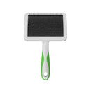 Pet grooming brush with a green handle on a white background