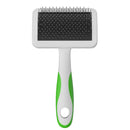 Pet grooming brush with black bristle side and green handle on a white background