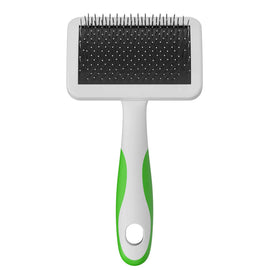 Pet grooming brush with black bristle side and green handle on a white background
