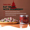 Freeze-dried cat grass with cranberry product on a wooden plate with packaging and festive design elements.